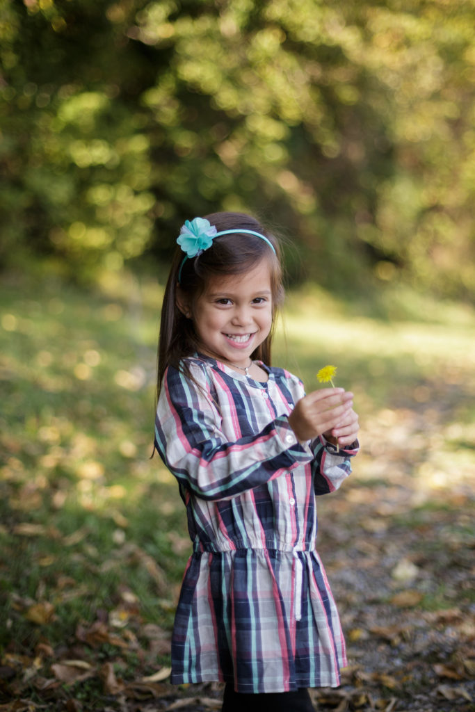 girl in patterned shirt and teal headband