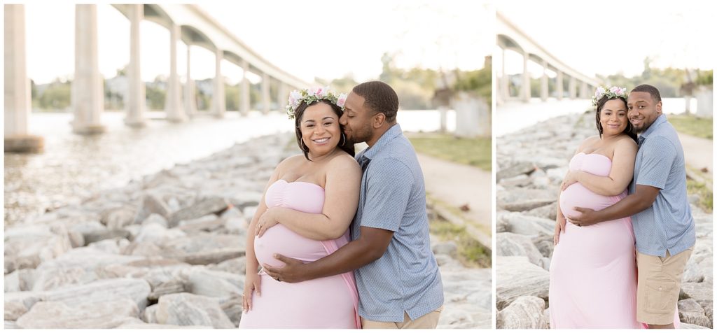 Husband and wife pose by Annapolis overpass during their beach maternity photos
