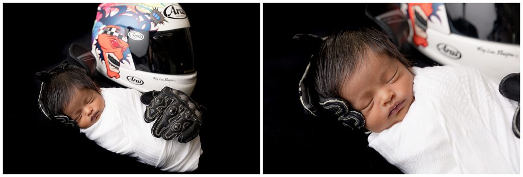Newborn baby posed with motorcycle helmet and gloves
