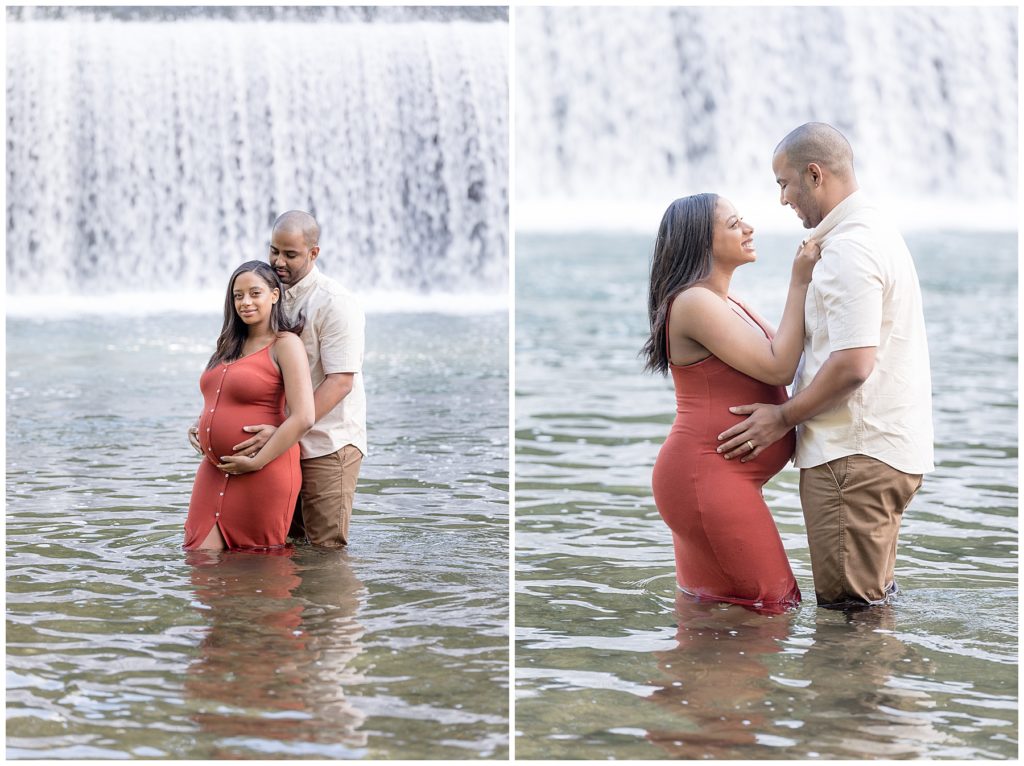 pregnant couple poses for photos in front of Maryland waterfall