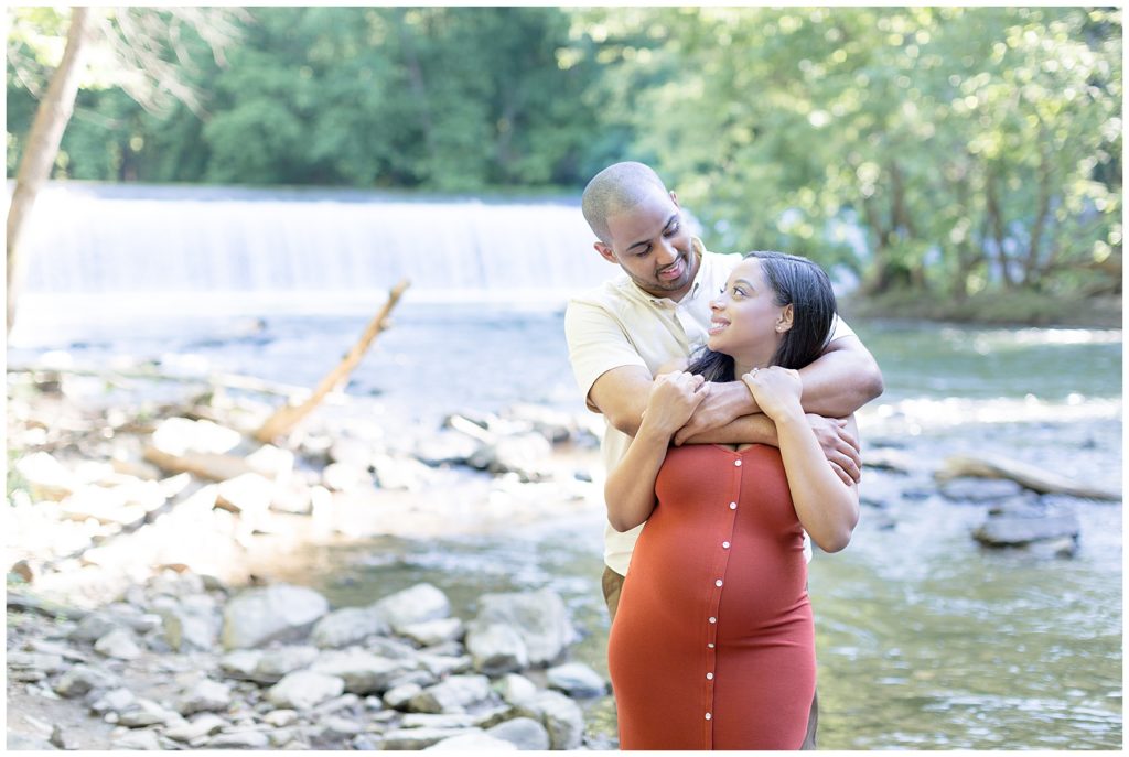 pregnant woman looks over shoulder at husband
