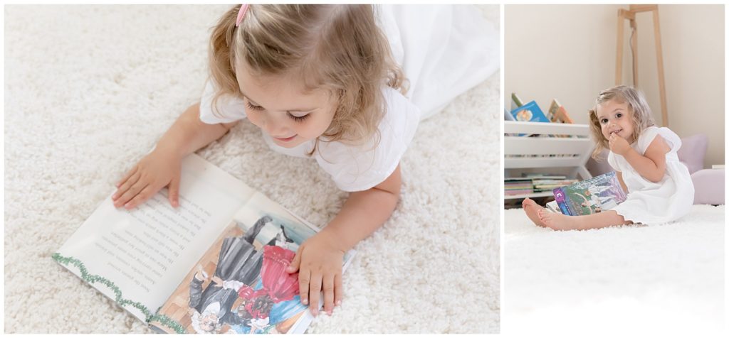 close-up of toddler reading a book in white bedroom