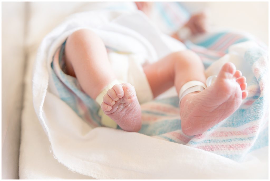 Tiny newborn toes wrapped in hospital blankets