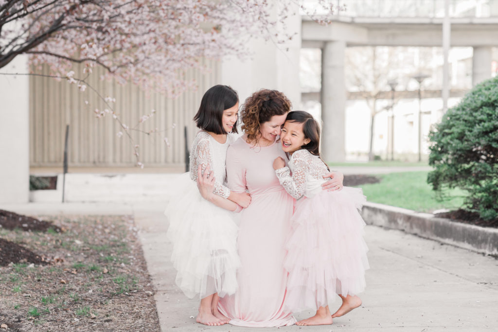 A mom and her girls giggle together at Columbia, MD, mommy and me session
