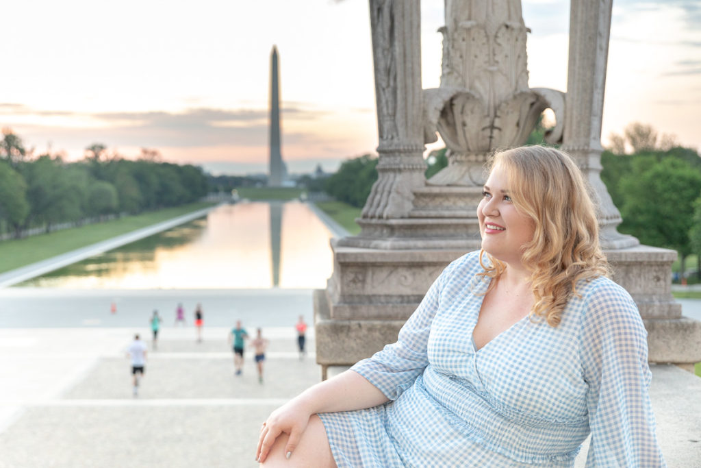 Graduate perches on steps of Lincoln Memorial