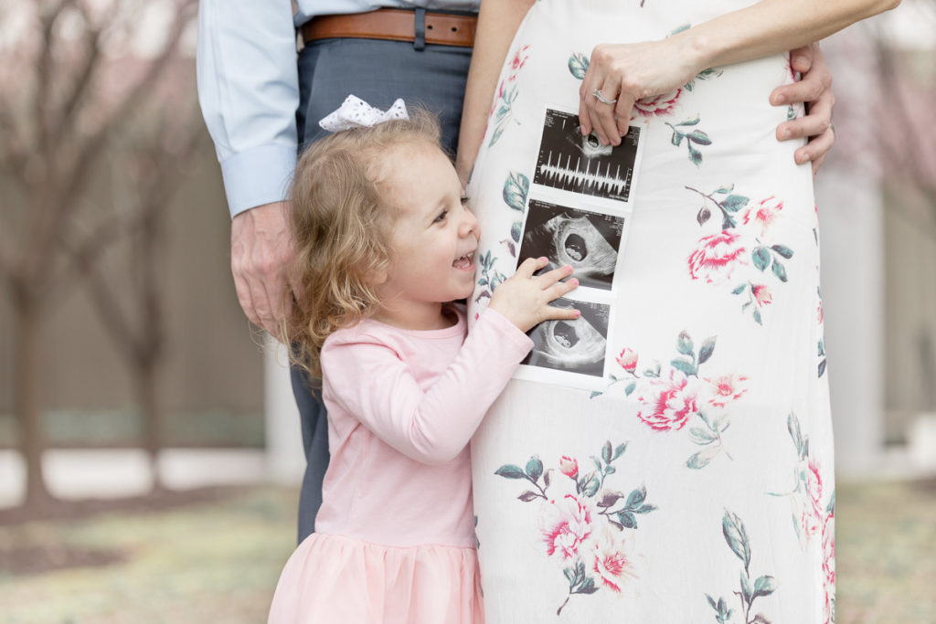 Little girl points at ultrasound of new baby brother