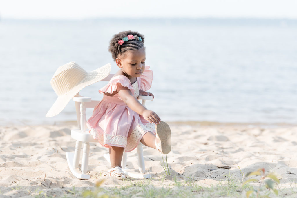 Emptying sand out of shoes during beach photo session