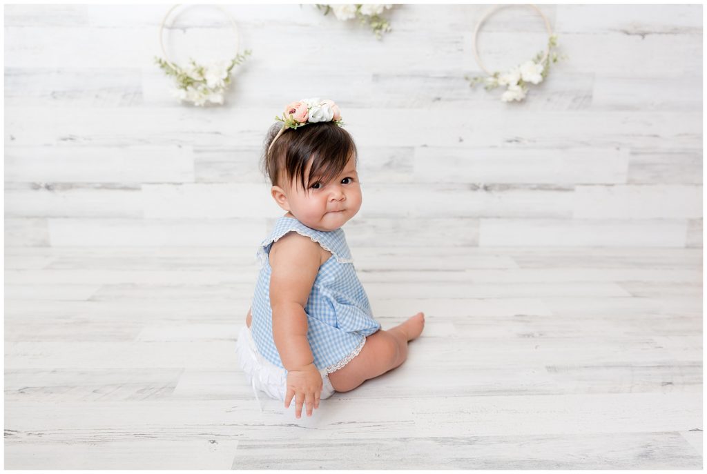 Six month old poses in the blue dress her mother wore as a baby!