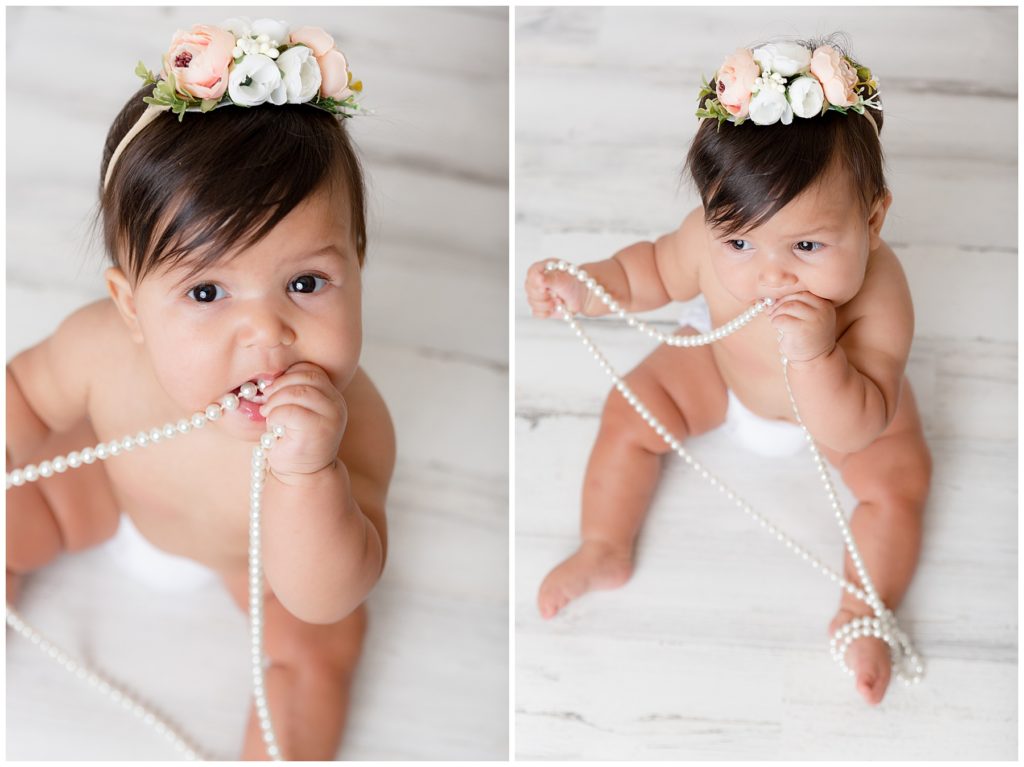 Baby chews on string of pearls during sitter session photos