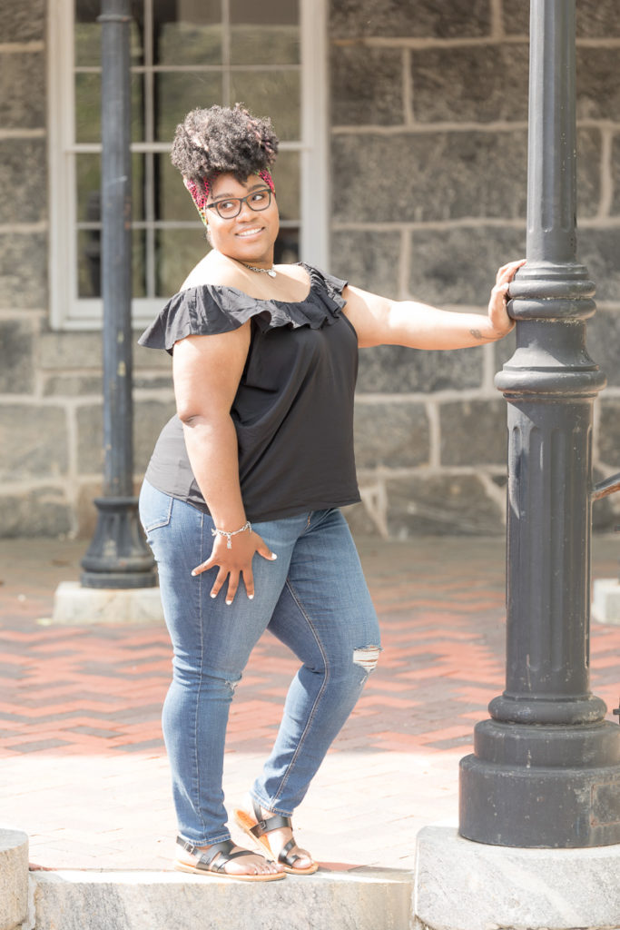 Local Maryland doula leans against Ellicott City lamppost during personal branding session photos