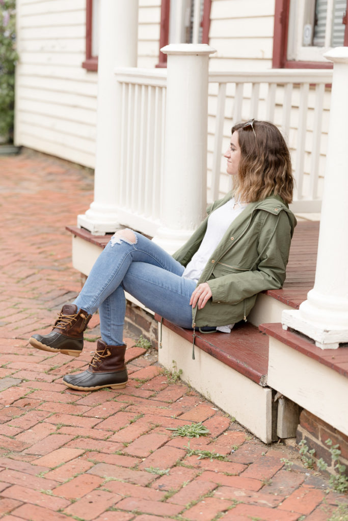 Senior girl perches on steps in downtown Annapolis