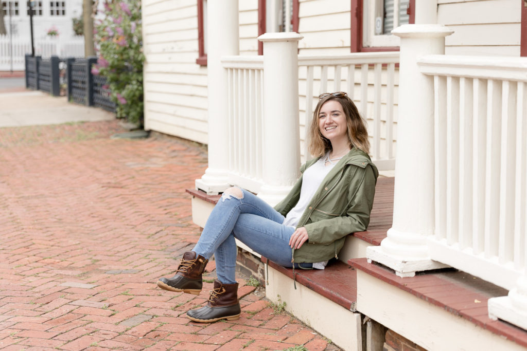 Teenager smiles at camera during senior portraits session