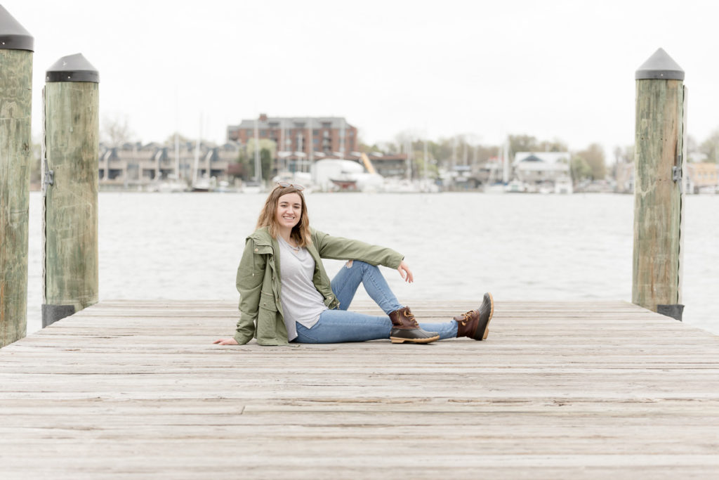 Girl poses on Annapolis dock during high school senior portraits