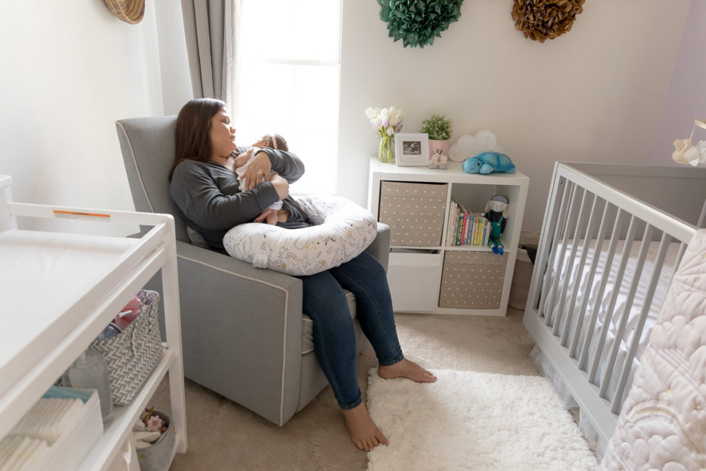 Mom gazes at baby's face during lifestyle newborn photos