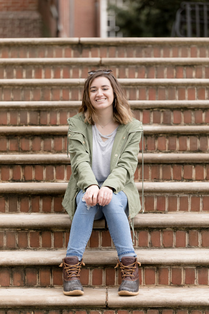 girl perches on steps at Annapolis State House