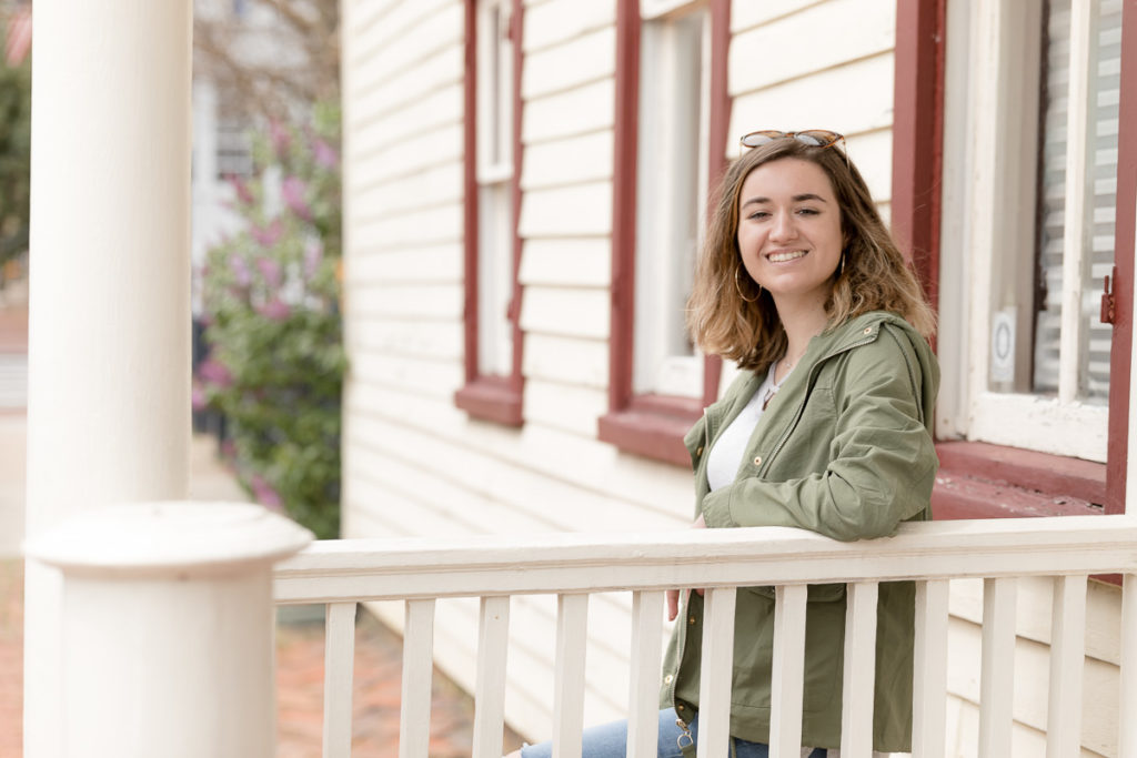 Teen leans against white railing in Annapolis