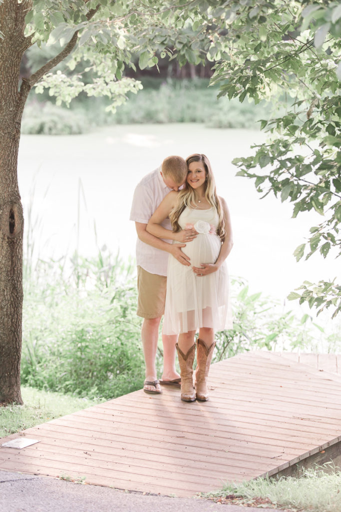 trees frame pregnant Anne Arundel county couple in Maternity and Newborn Photography