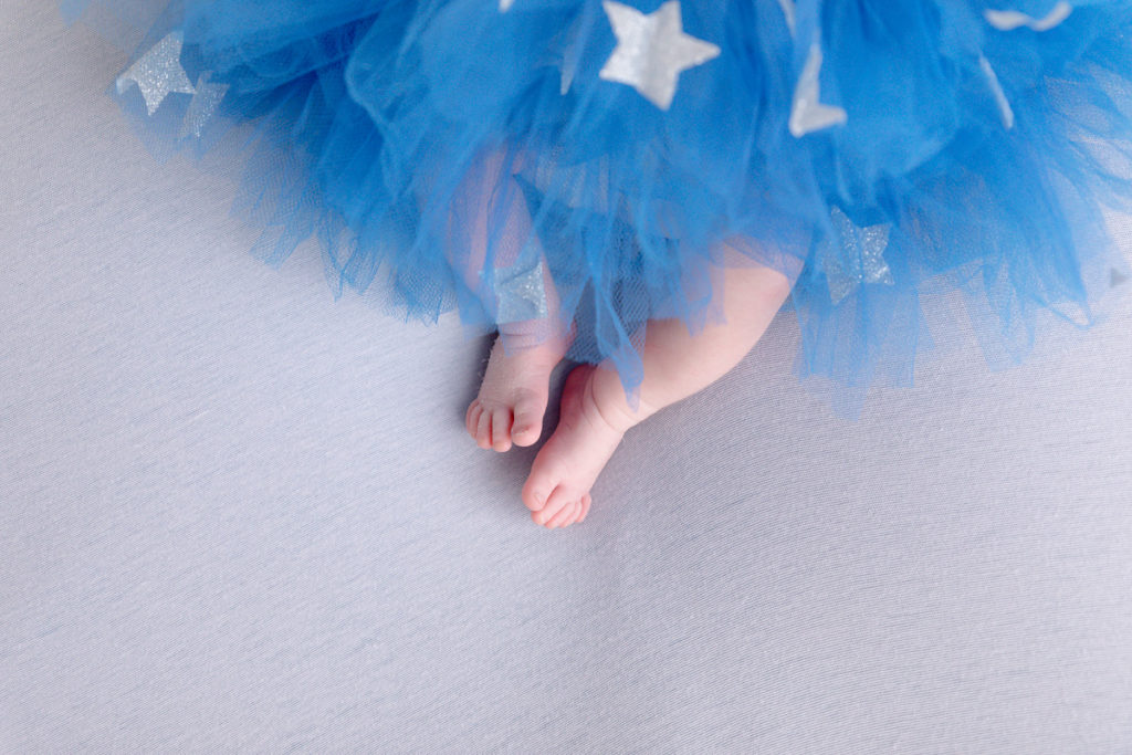 newborn baby toes and blue tutu