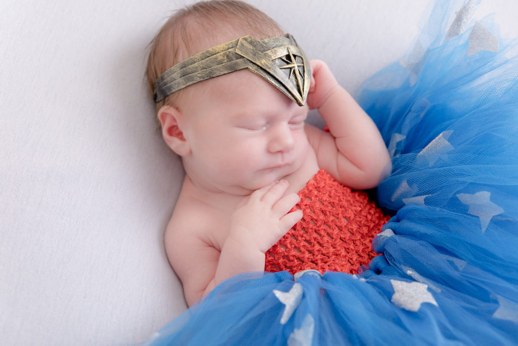 newborn baby dressed in Wonder Woman costume