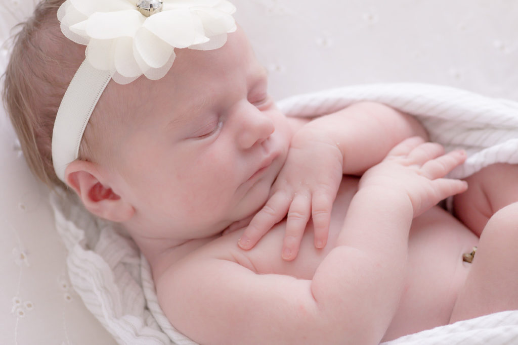 sleeping newborn girl in white