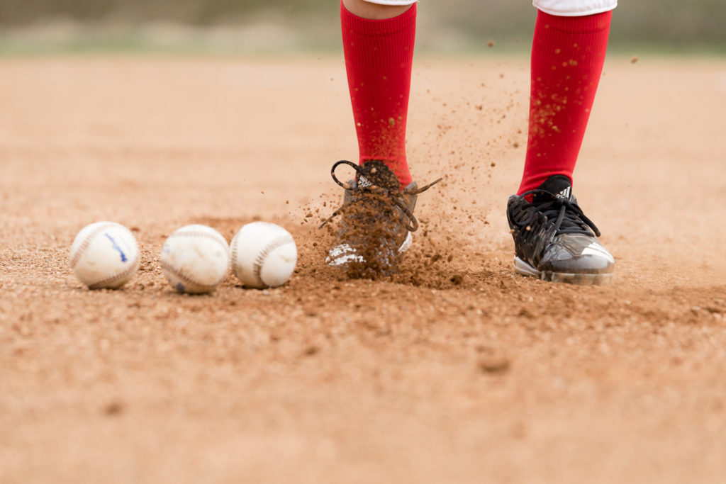 boys kicks dirt during baseball photo session