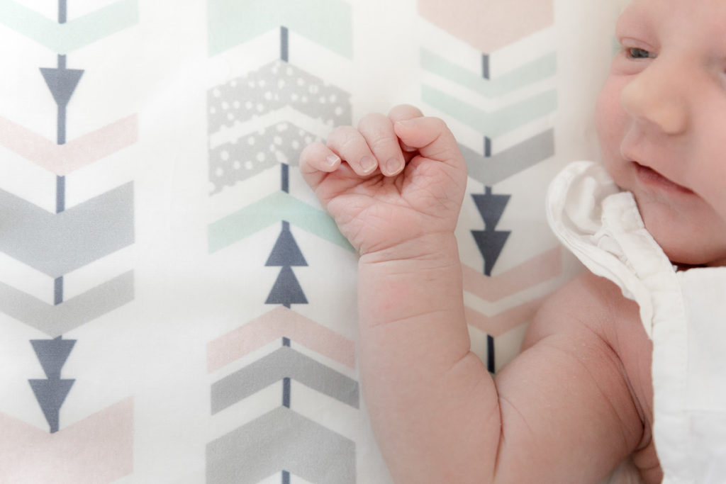 new baby rests in crib during In-home Newborn Photos