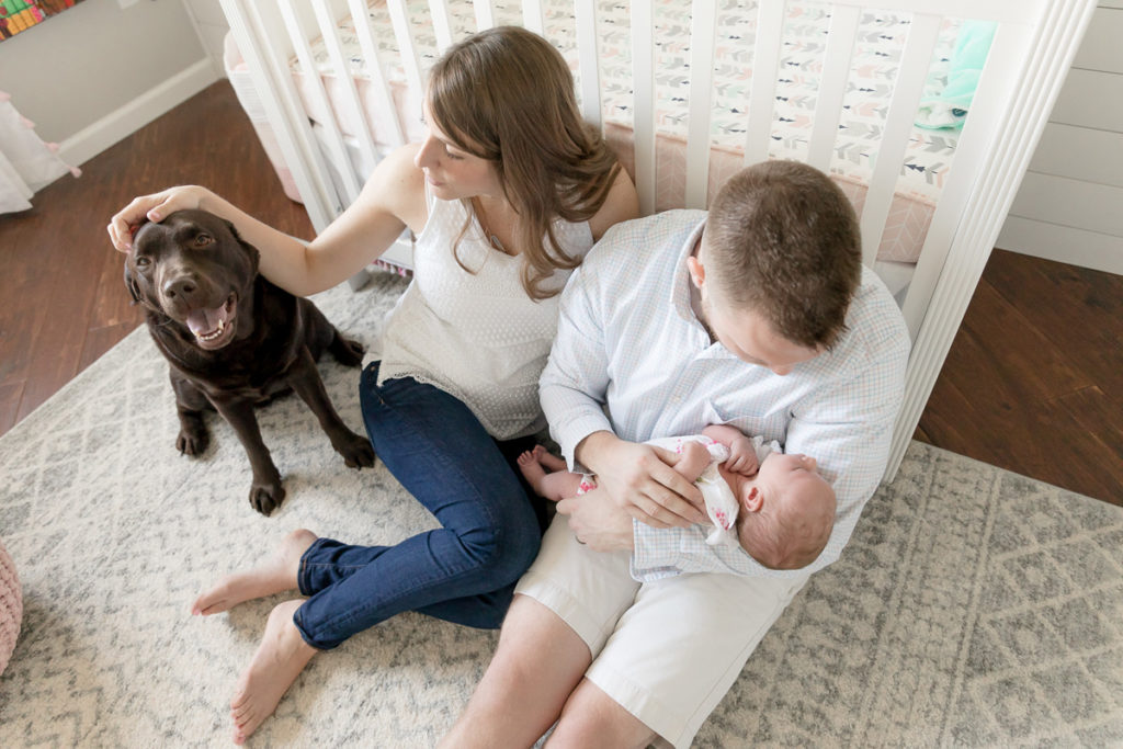 new mom pets dog during In-home Newborn Photos