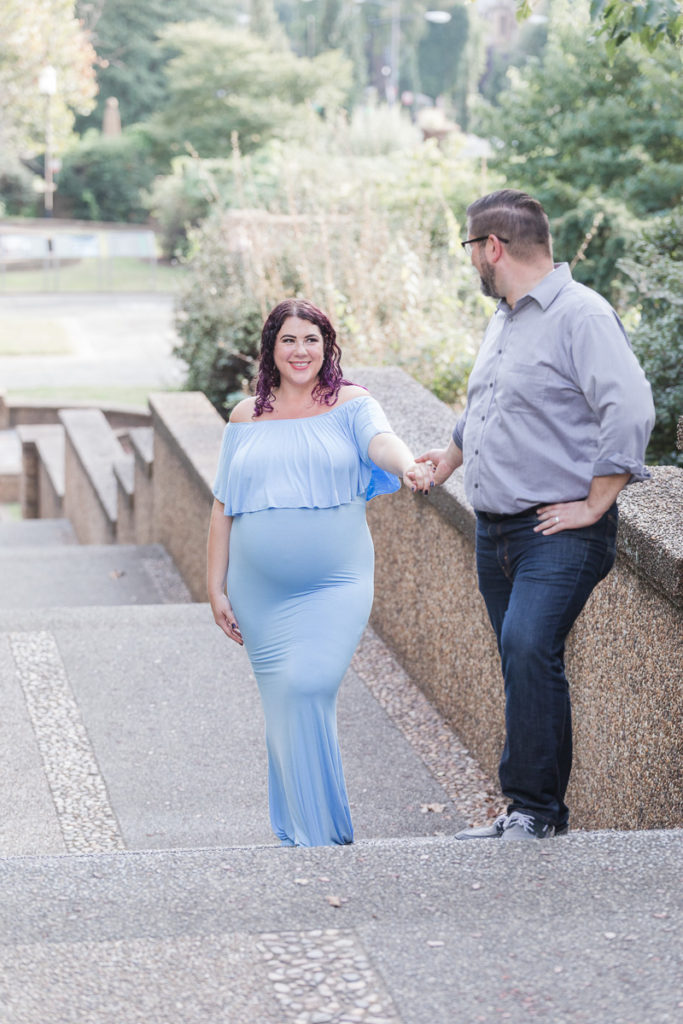 husband assists pregnant wife up Meridian Hill Park stairs