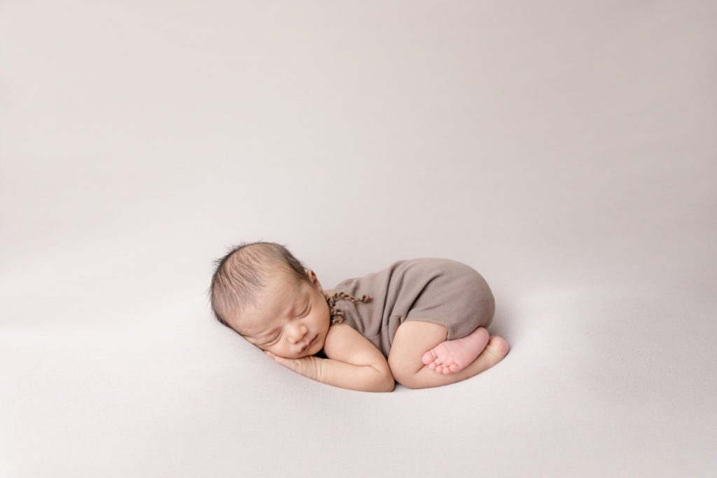 newborn womb pose, trying to decide on a newborn photo session
