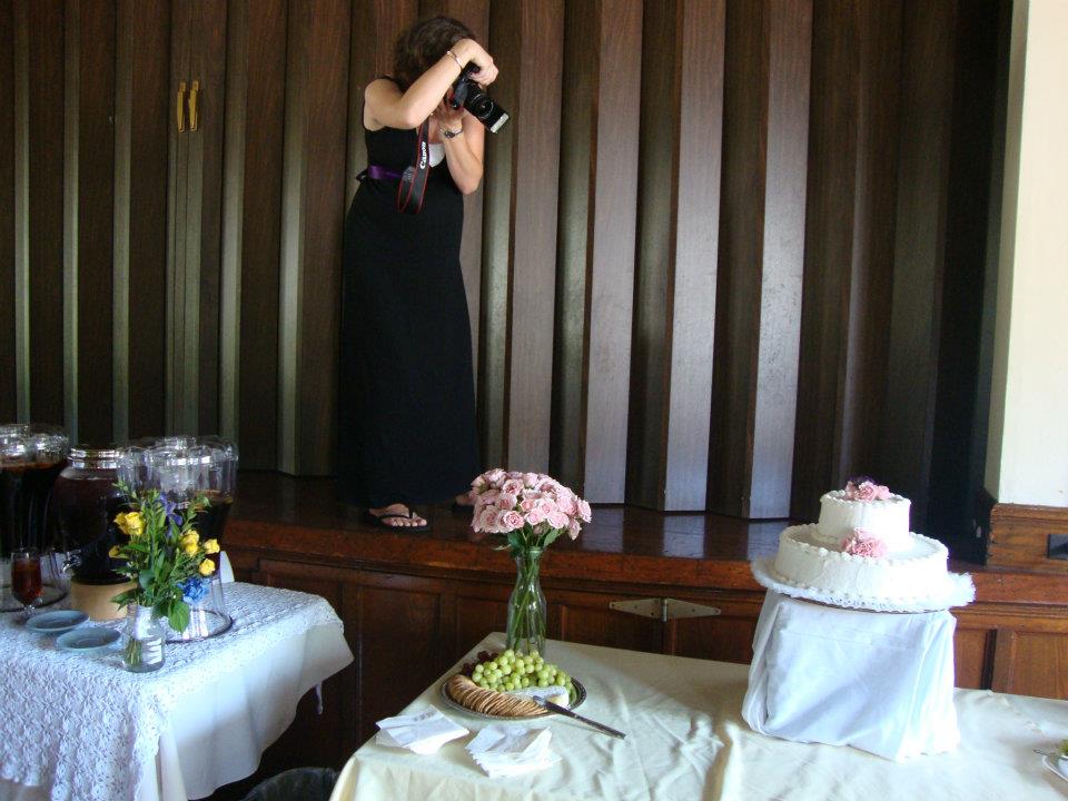 pregnant woman photographing a wedding cake