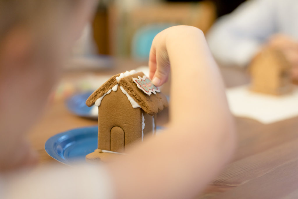 girl fixes gingerbread house "It's not that bad"
