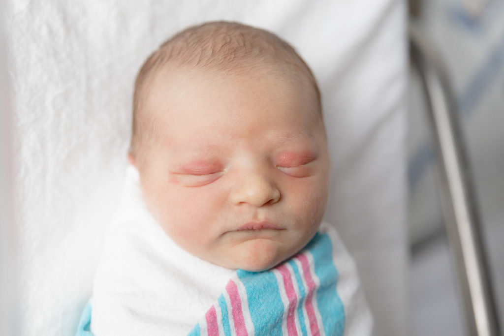 closeup of newborn face taken during newborn photos right after birth