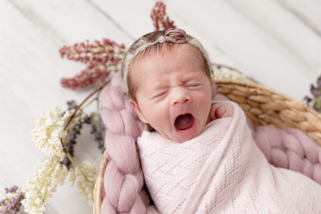 yawning newborn in Maryland newborn photography studio