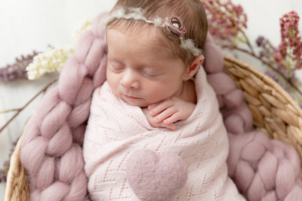 swaddled baby with heart and headband