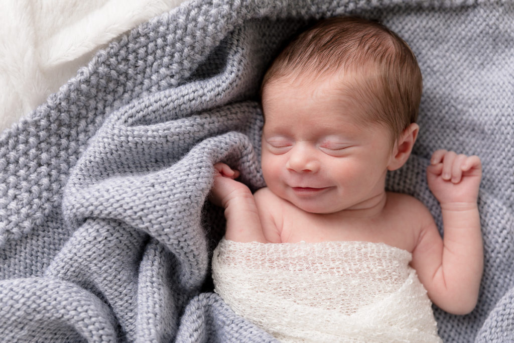 cute newborn smile during photos