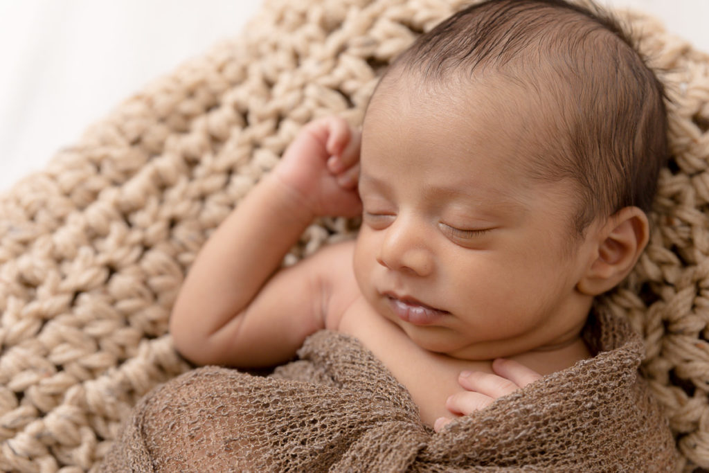 newborn boy posed in brown