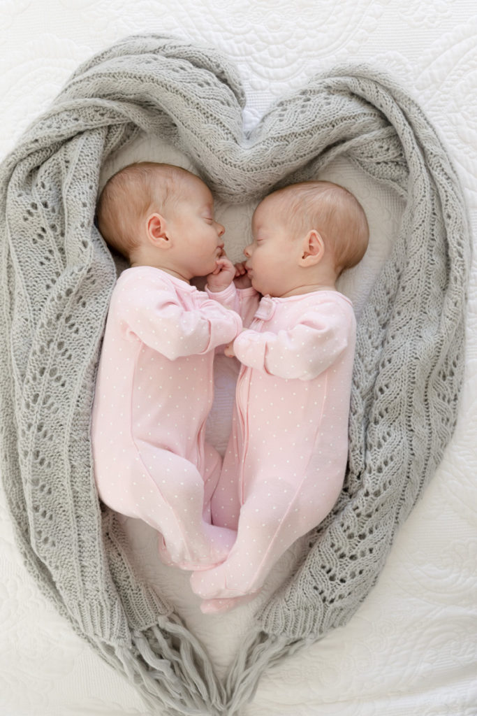 twins framed in heart-shaped blanket