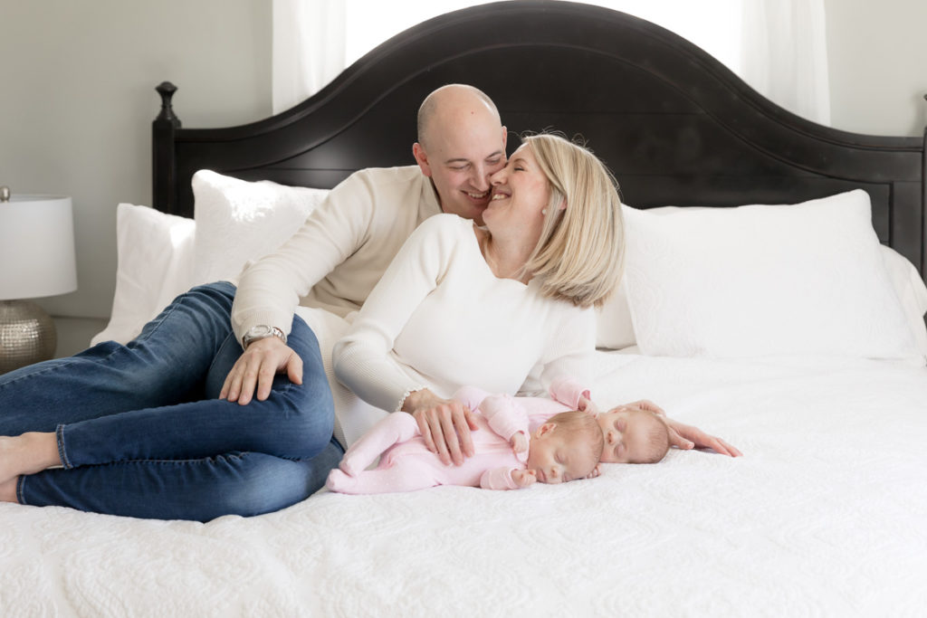 parents canoodle during newborn twin session
