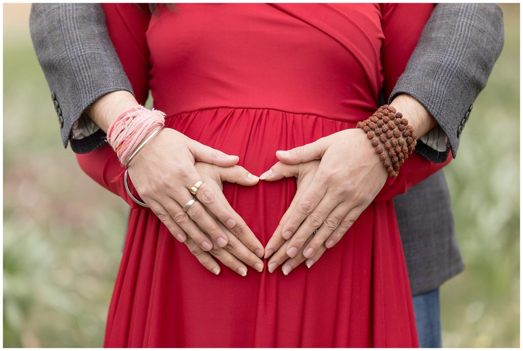 hands on belly, red maternity dress
