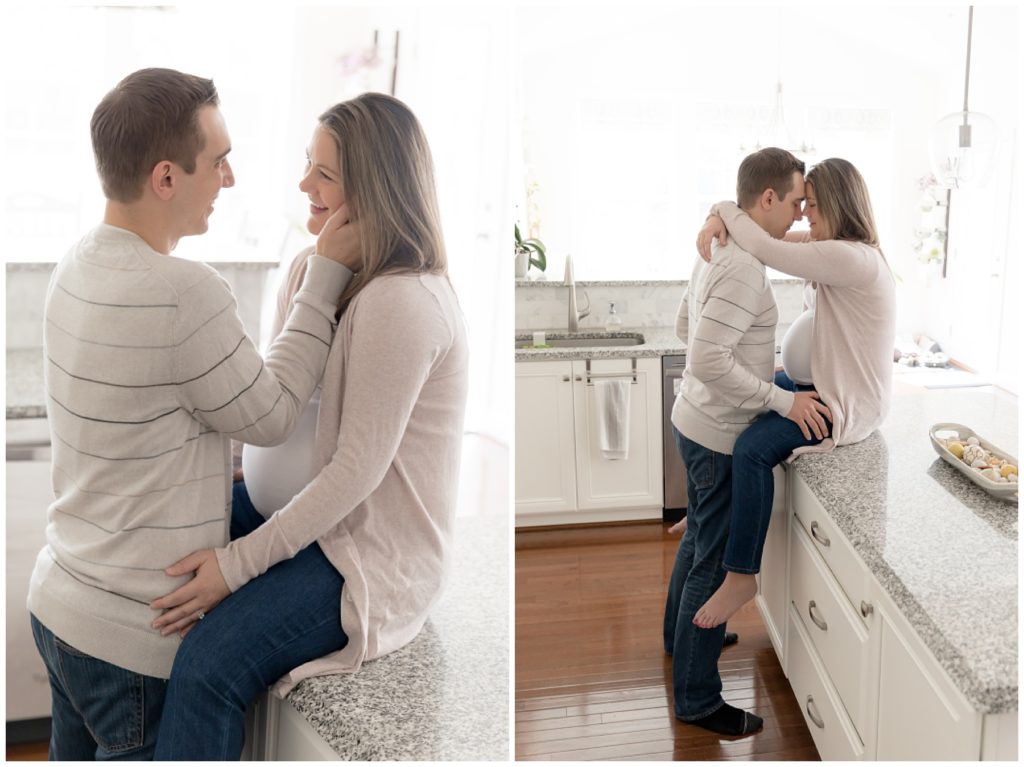 cute pregnant couple poses for photos in white kitchen