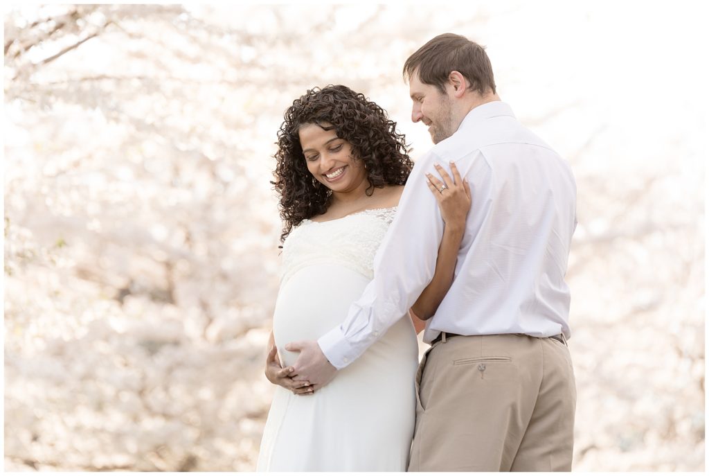 pregnant wife laughs at husband during photos