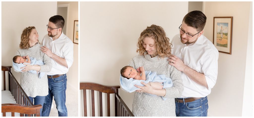 new parents stand next to crib in newborn photos at home
