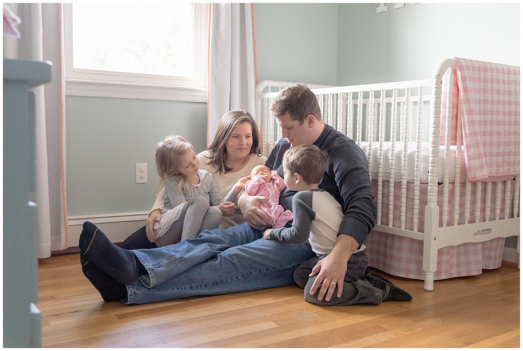 family photo with newborn in light-filled nursery