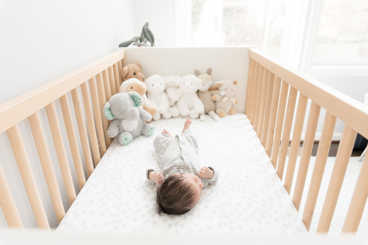 baby lying in light filled nursery