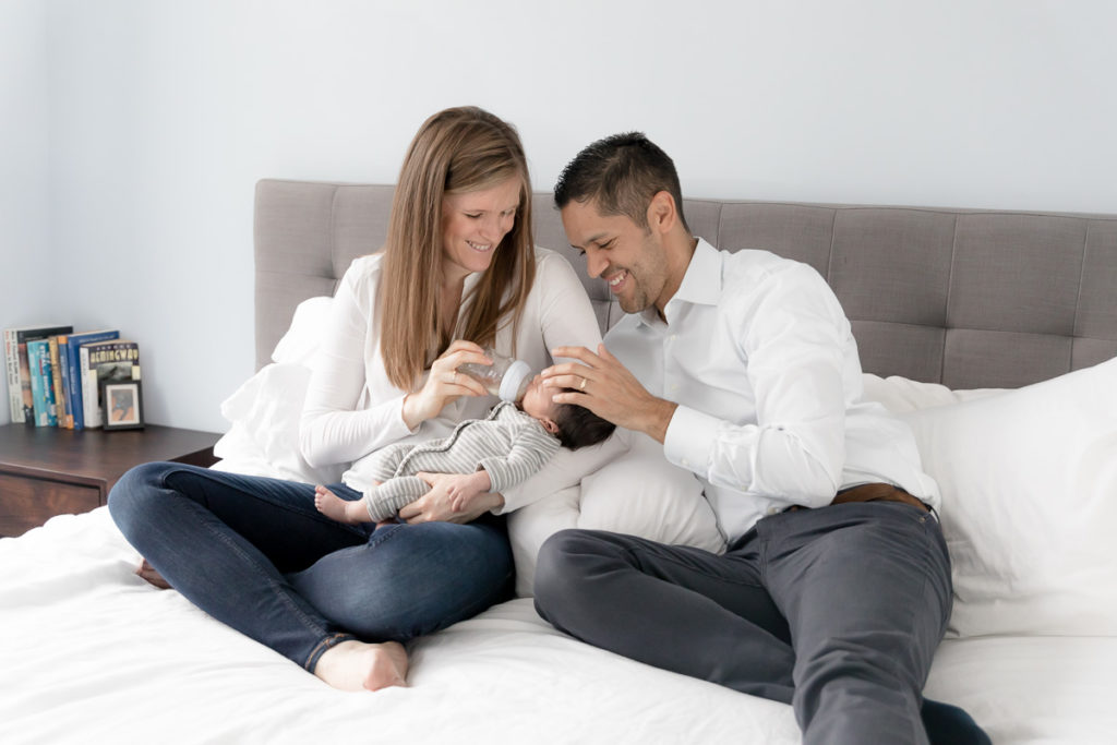 parents share a laugh over newborn