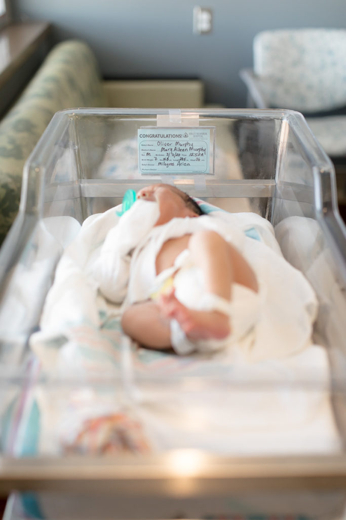 newborn baby in bassinet