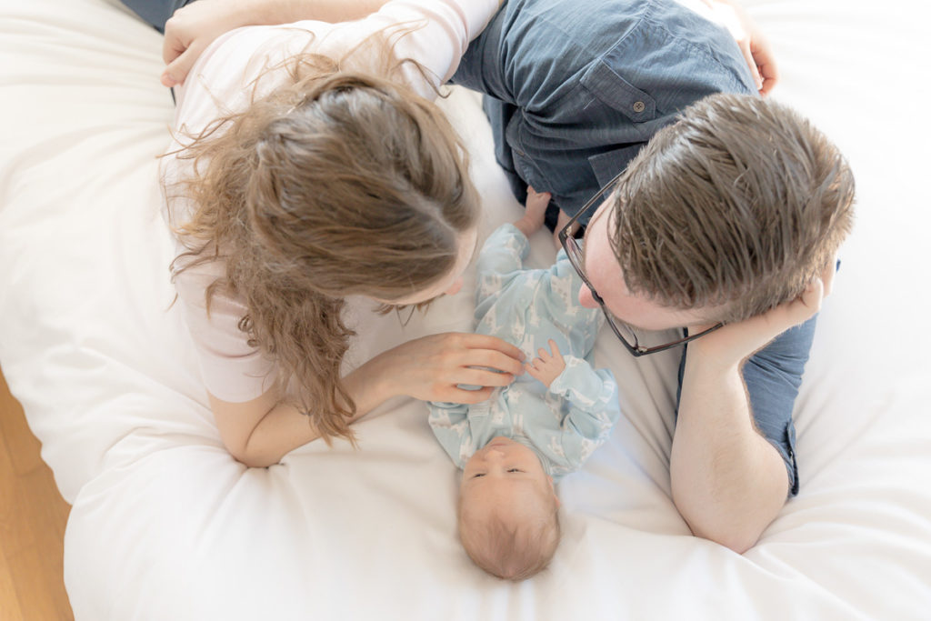 mom and dad relax with newborn son