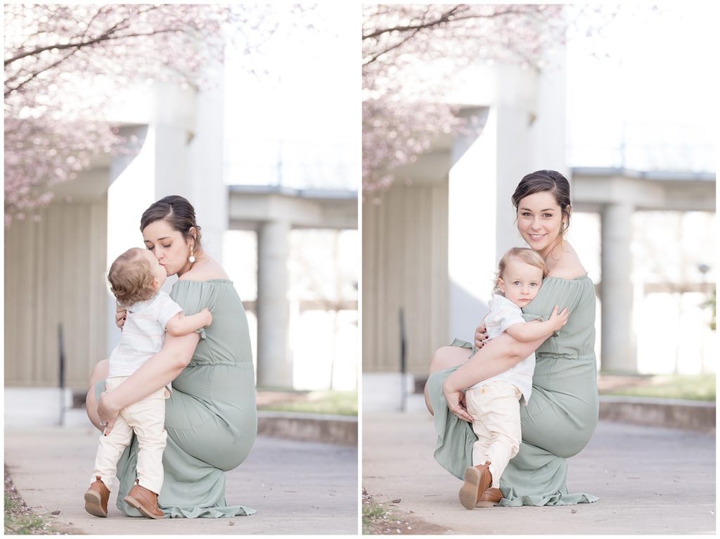 mom hugs toddler son under spring cherry blooms