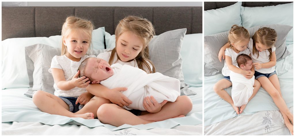 Maryland newborn photographer catches big sisters holding baby brother