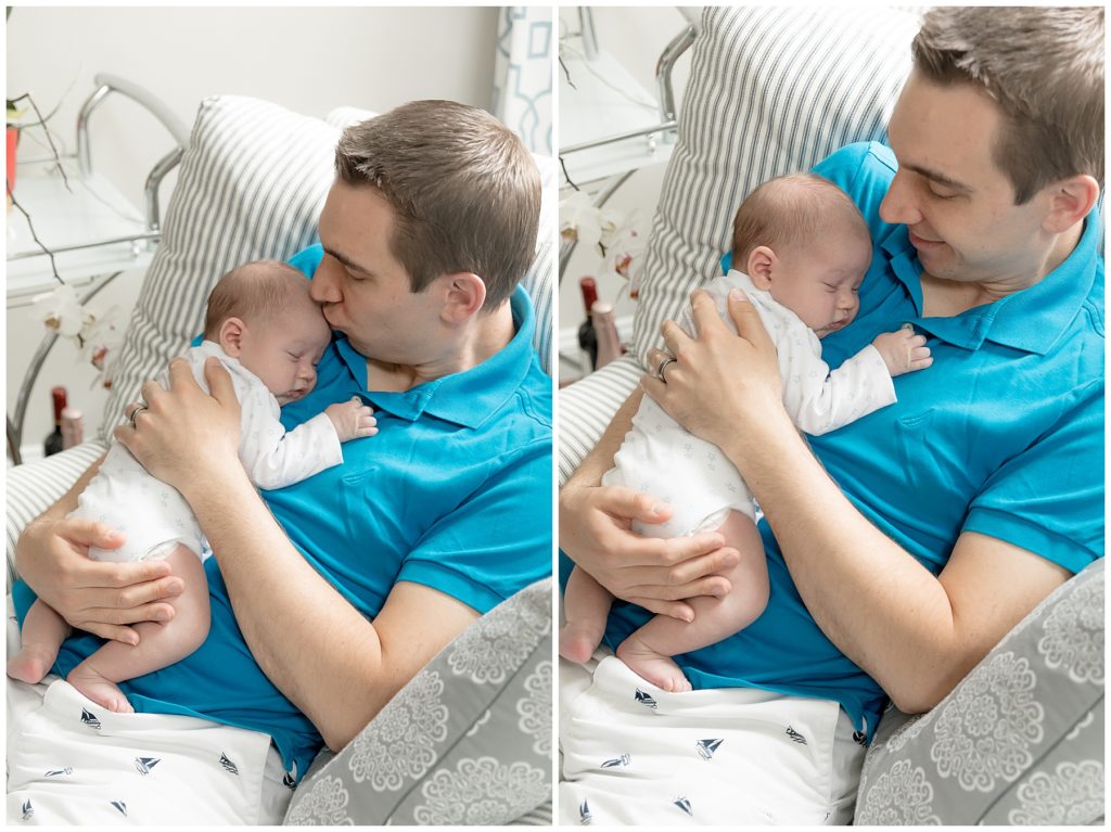 dad in blue, baby in white snuggling in chair